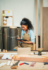 Business People African American Woman Managing Small Craft Business Using Tablet to Design...