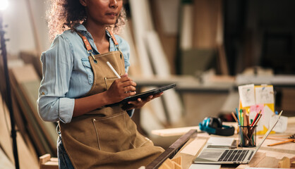 Business People African American Woman Managing Small Craft Business Using Tablet to Design...
