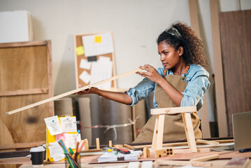 Woodworking Woman Creating Handmade Woodcraft in Small Factory Workshop, Focusing on Design, Detail...