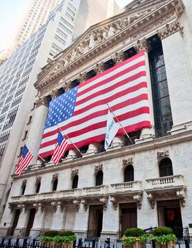 New York, 3rd August 2012; New York Stock Exchange facade on Wall Street with a large United States Flag