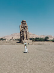 Tourist visiting the colossi of memnon in luxor, egypt during a sunny day