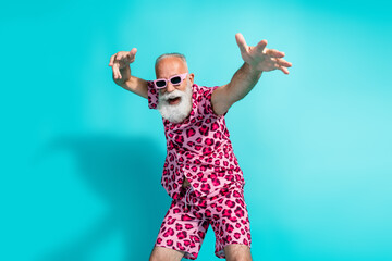 Portrait of funky aged man chill dance wear leopard print costume isolated on turquoise color...