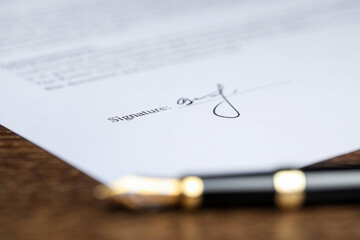 Notary document and fountain pen on wooden table, selective focus