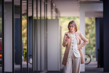 Professional Woman Using Smartphone in Modern Office Space