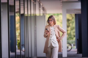 Professional Woman Using Smartphone in Modern Office Space