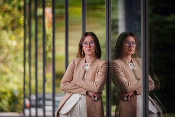 Confident Woman Posing with Arms Crossed by Glass Wall