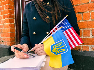 Woman with Ukraine and USA flags, symbol of support, war and second home