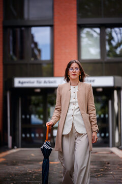 Businesswoman Leaving Job Center with Determined Expression
