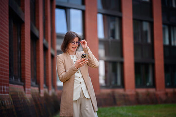 Smiling Businesswoman Checking Smartphone Outdoors