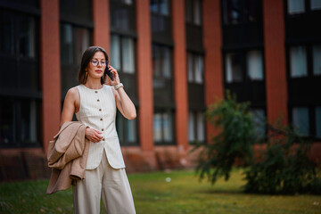 Businesswoman Talking on Phone Near Office Building