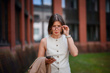 Surprised Businesswoman Looking Over Glasses