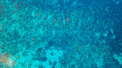 Stunning aerial view of the Surin Islands coastline with its lush green forests, coral reefs and deep blue waters filled with coral and a variety of fish, making it a popular destination for divers