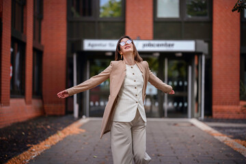 Joyful Woman Spinning Outside Jobcenter Building
