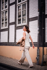 Woman Approaching Historic Half-Timbered House