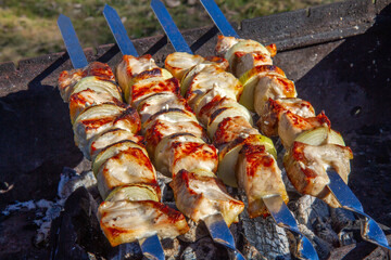 Fish skewers with onions, cooked on charcoal.