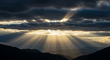 Sunbeam Breaking Through Dramatic Clouds Over Mountain Peaks