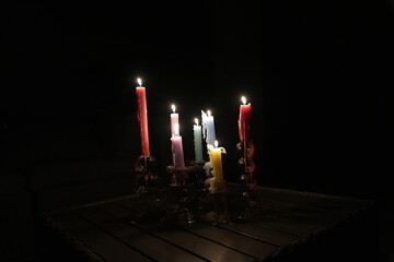 Candle flames in darkness reflecting occult energy, sacred rituals, mystic traditions, hidden...