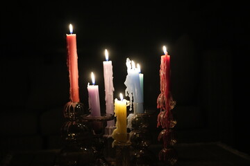 Candle flames in darkness reflecting occult energy, sacred rituals, mystic traditions, hidden...