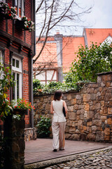 Woman Walking Through Quaint Alley with Laptop Sleeve