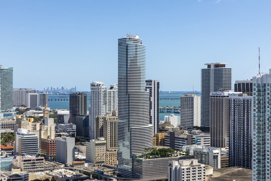 Aerial view of the gleaming Panorama Tower piercing the skyline, with Biscayne Bay shimmering in the distance, Miami, Florida, United States.