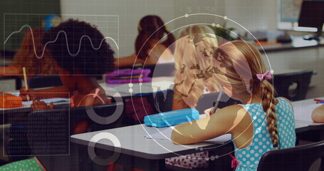Writing five primary school girls focusing on notebooks at desks in classroom, with digital overlay