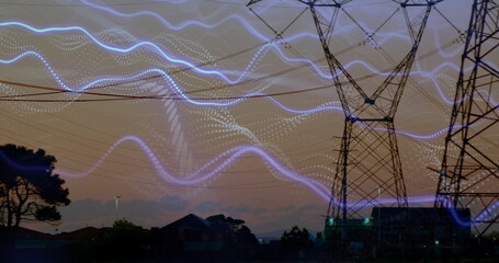 Dominating tower stretching power lines over rooftops at twilight, blue light trails, copy space