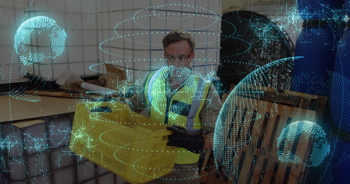 Wearing safety vest, worker holding yellow crate in warehouse, with pallets and holographic overlay - Powered by Adobe