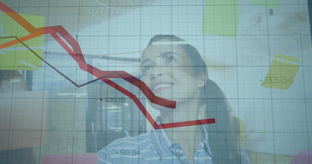 Watching businesswoman analyzing projected data grid in office conference room, with red trend line