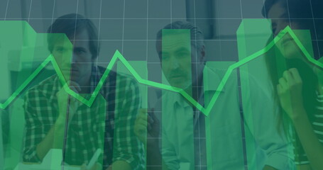 Analyzing business team studying chart overlay with gridlines in boardroom, with pens notebooks