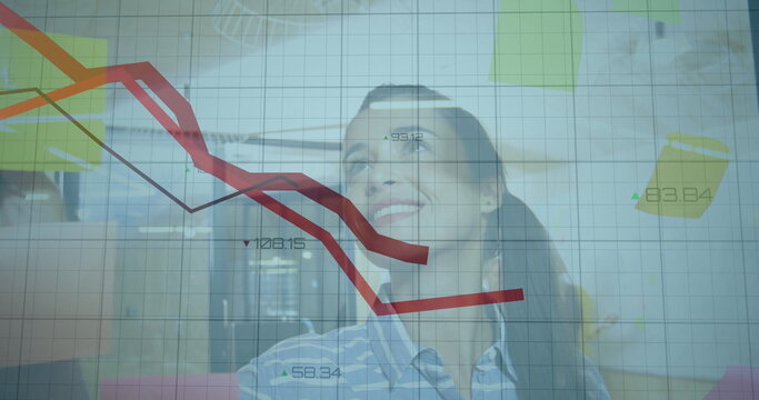 Watching businesswoman analyzing projected data grid in office conference room, with red trend line