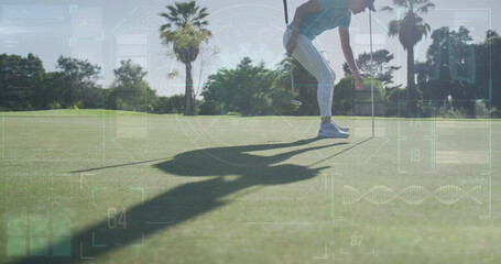 Bending golfer holding flagstick and grabbing golf ball on putting green in sportswear, copy space