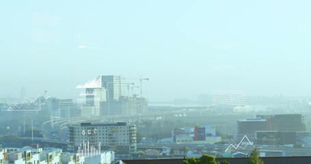 Showing towers rising with cranes above highways and blocks in urban outskirts with data overlays