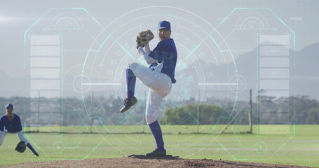 Wearing blue uniform, baseball pitcher winding up on dirt mound at baseball field, with glove