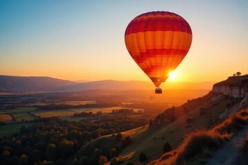 Obraz premium Vibrant Hot Air Balloon Ascending at Sunrise, Casting a Long Shadow Across Serene Landscape. A Breathtaking Scene of Exploration and Adventure, Perfect for Travel and Vacation Themes.