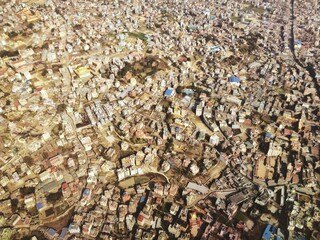Aerial view of Kathmandu, Nepal, from an airplane. Captures the city’s dense urban layout with...