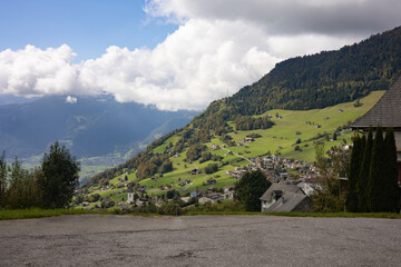 Picturesque Alpine Village Nestled on a Green Mountain Slope