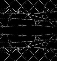 white barbed wire of net wired fence isolated on black background. barbed wire silhouette on dark...