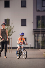 Happy Young Boy Riding Bicycle on Sunny Urban Street