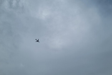 Airplane Silhouette Against Cloudy Sky - Tranquility and Wanderlust for Travel Themes