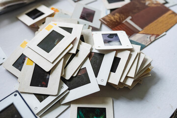 Stack of vintage photo slides scattered on a white table