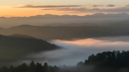 Misty Sunrise Over Mountain Ranges