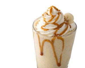 Close up view of peanut butter banana shake with banana slices and creamy whipped topping