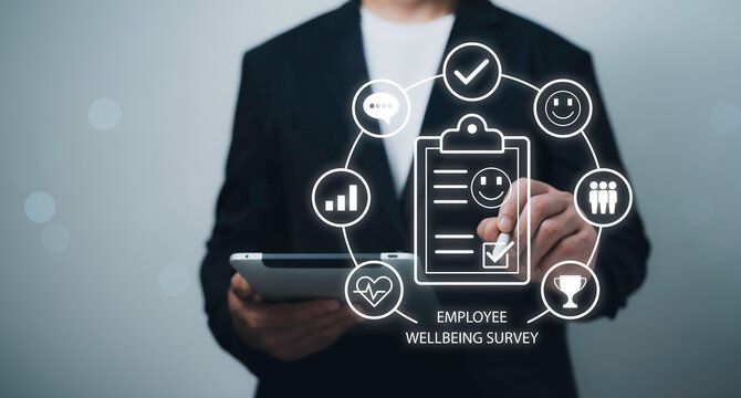 Businessman using tablet with wellbeing survey icons employee satisfaction workplace feedback mental health HR performance review corporate care digital evaluation engagement
