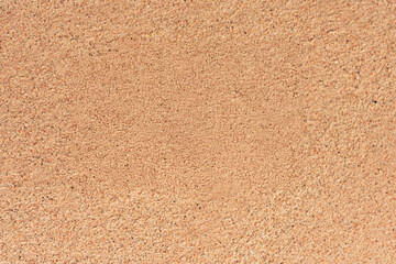 Close-up of smooth fine beach sand texture in soft sunlight, ideal for natural backgrounds or...