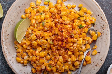 Esquites is a popular mexican street food dish made with grilled corn kernels, mayonnaise, cheese,...