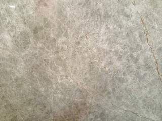 Glossy brown marble texture with faint white veins.

