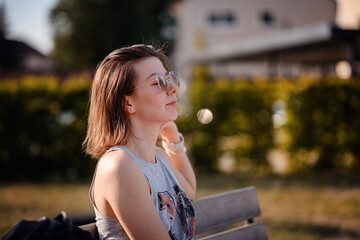 Young Woman Relaxing Outdoors in Summer Sunlight