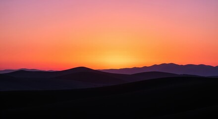 Vibrant Sunset Over Dark Mountain Silhouettes At Dusk