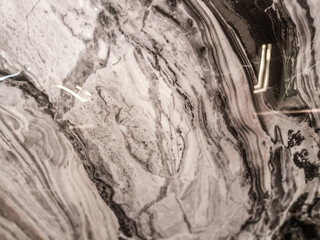 Marble texture with dark grey and white veins, giving a strong impression.

