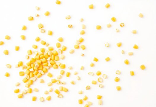 Bright yellow fresh corn kernels scattered on pristine white background,   agricultural,   stock photo